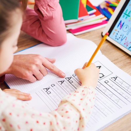 little girl writing on paper