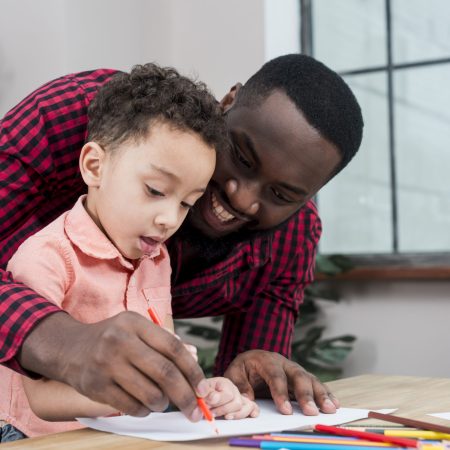 happy-black-father-son-drawing-table